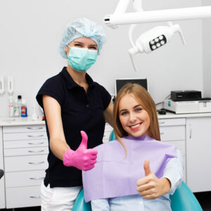 girl being treated by dentist